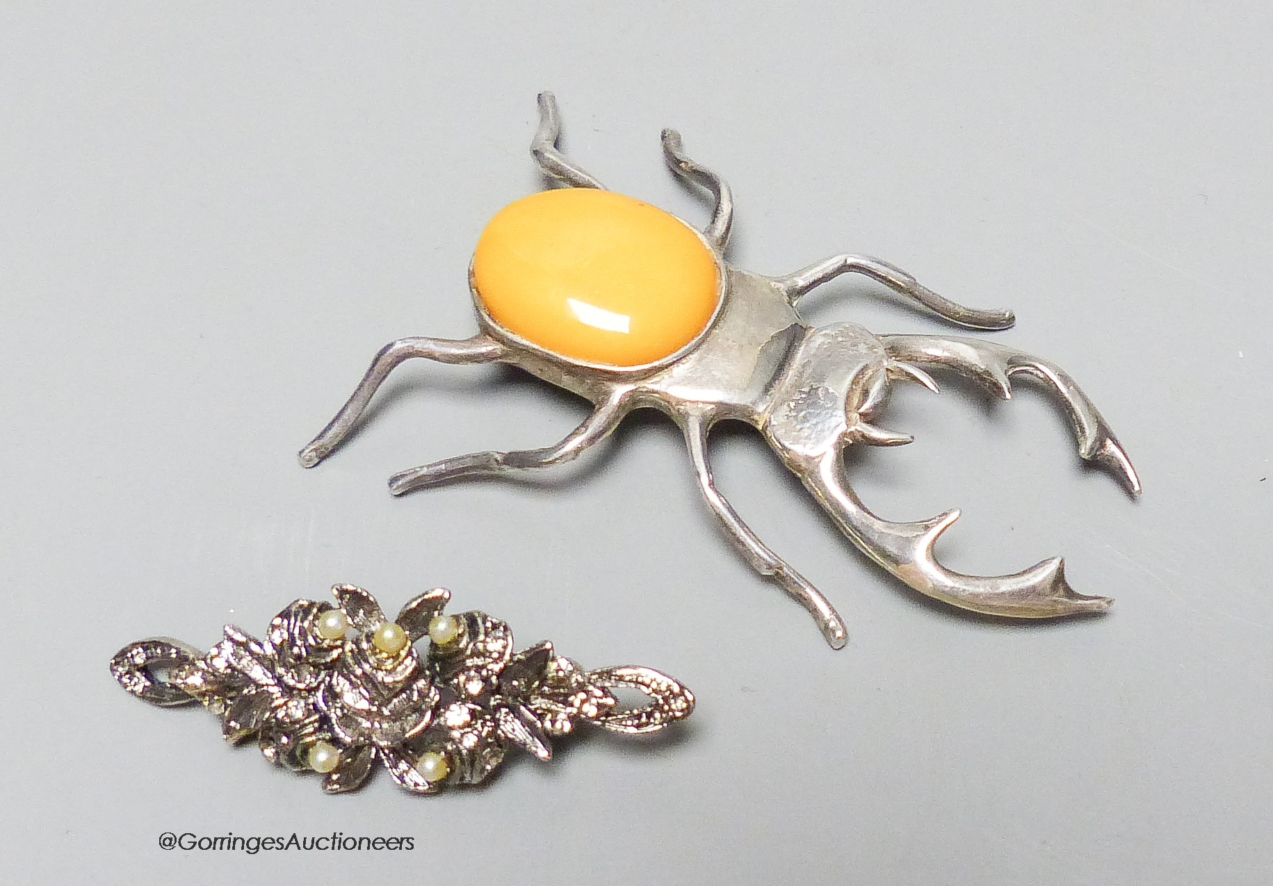 A silver and amber stag beetle brooch